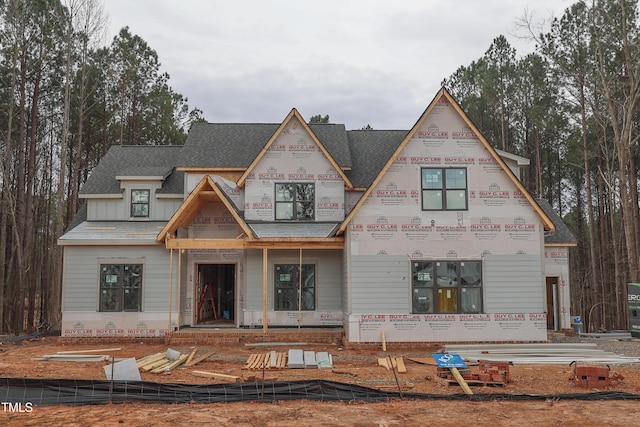 property in mid-construction with a shingled roof