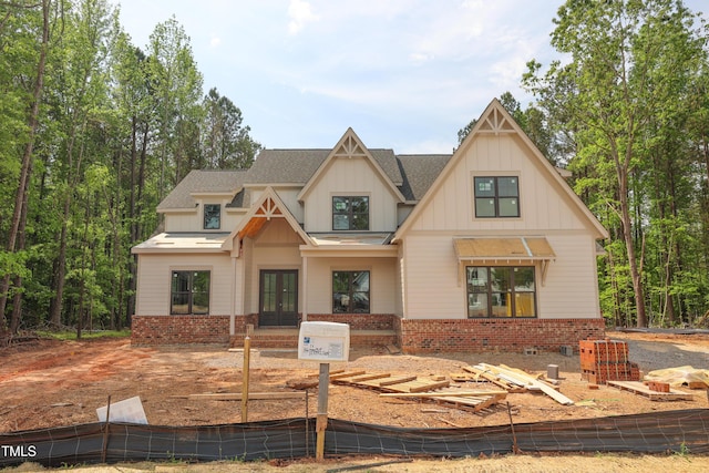 1236 Perry Bluff Dr, Wake Forest, NC 27587 - view of front of property featuring french doors, brick siding, board and batten siding, and a shingled roof