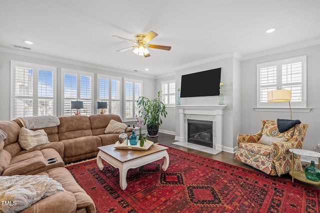 living room featuring ceiling fan, crown molding, and hardwood / wood-style floors