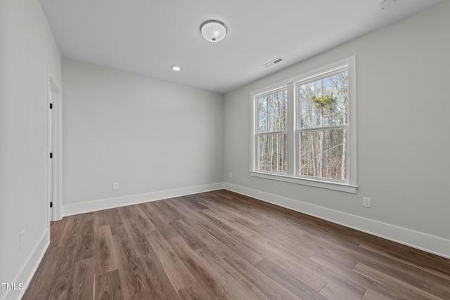 spare room featuring hardwood / wood-style floors