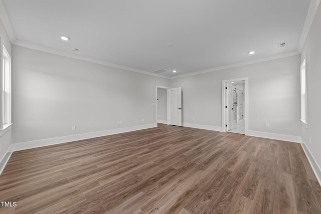 unfurnished room featuring crown molding and wood-type flooring