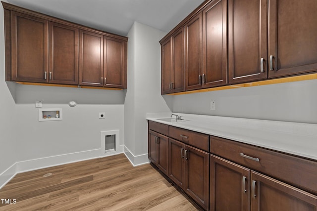 laundry area featuring gas dryer hookup, sink, cabinets, washer hookup, and hookup for an electric dryer