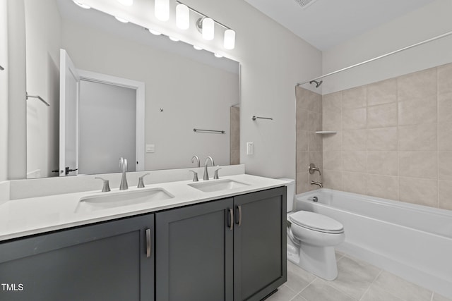 full bathroom with tiled shower / bath, vanity, toilet, and tile patterned flooring