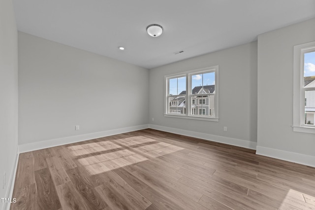 unfurnished room with light wood-type flooring