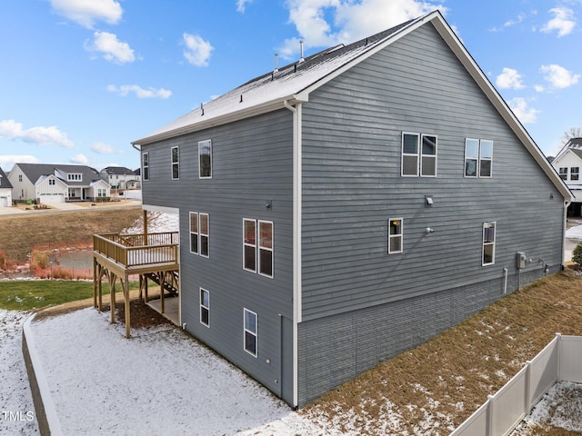 view of property exterior with a wooden deck