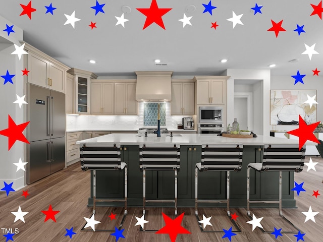 645 Silvercomet Dr, Knightdale, NC 27545 - kitchen featuring stainless steel appliances, custom range hood, light countertops, wood finished floors, and a large island