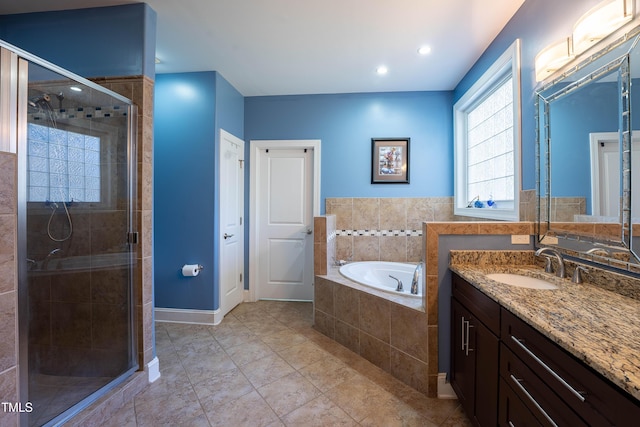 bathroom with vanity and separate shower and tub