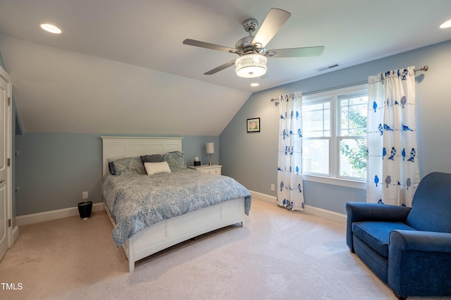 bedroom with vaulted ceiling, light carpet, and ceiling fan