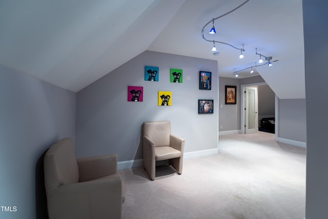 sitting room with track lighting, lofted ceiling, and carpet flooring