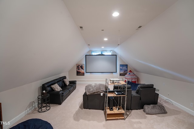 carpeted home theater room with lofted ceiling