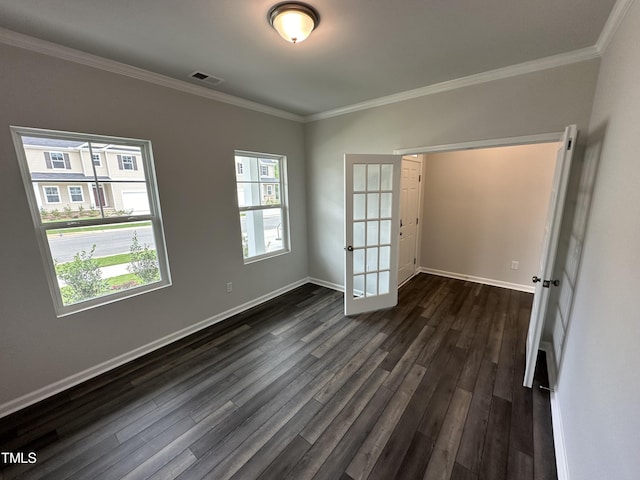 spare room featuring crown molding, dark hardwood / wood-style floors, and french doors