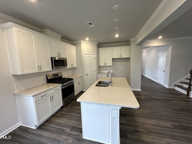 kitchen featuring a kitchen island with sink, sink, white cabinetry, and appliances with stainless steel finishes