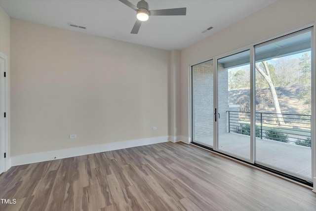 empty room with ceiling fan and light hardwood / wood-style floors