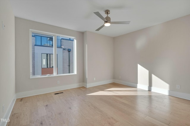 spare room with light hardwood / wood-style flooring and ceiling fan