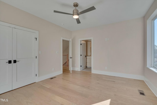 unfurnished bedroom with light hardwood / wood-style flooring, a closet, and ceiling fan