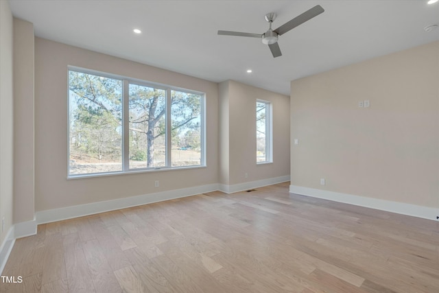 spare room featuring ceiling fan and light hardwood / wood-style flooring