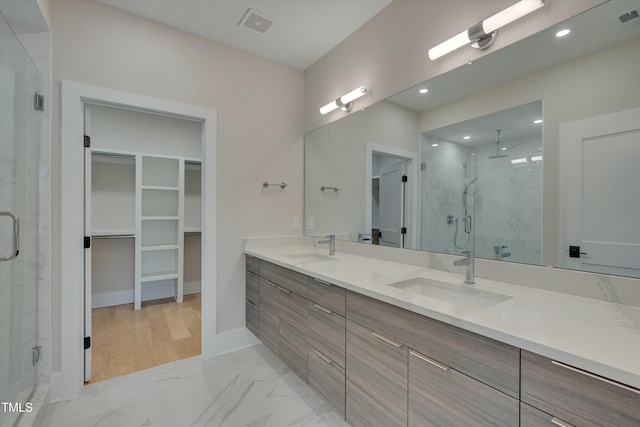 bathroom featuring vanity and a shower with door