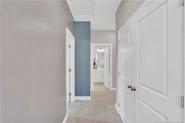 hallway featuring light colored carpet