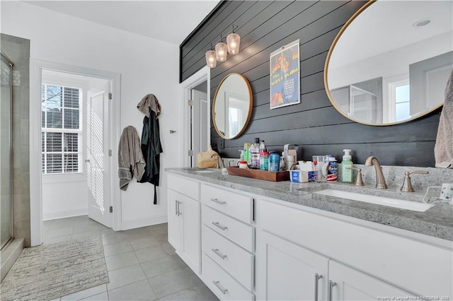 bathroom with vanity, an enclosed shower, tile patterned floors, and wood walls