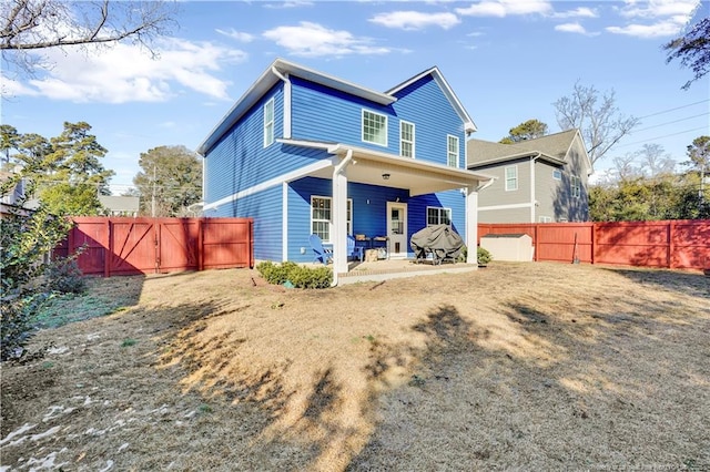 back of house featuring a yard and a patio area