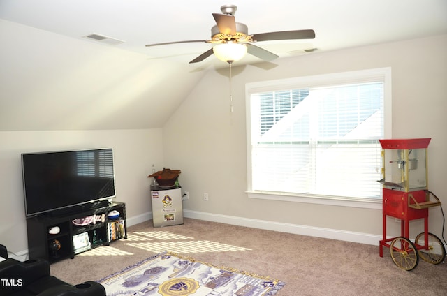 interior space featuring ceiling fan, lofted ceiling, and light carpet