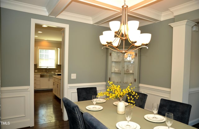 dining space featuring crown molding, dark hardwood / wood-style flooring, sink, and beamed ceiling