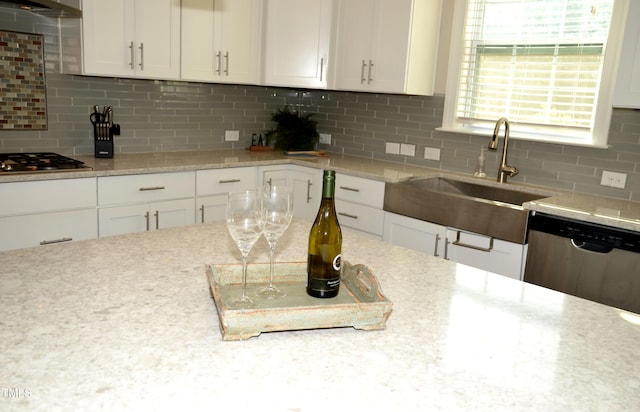 kitchen with white cabinetry, appliances with stainless steel finishes, and backsplash