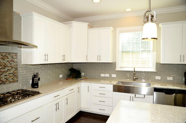 kitchen with appliances with stainless steel finishes, wall chimney range hood, sink, and backsplash