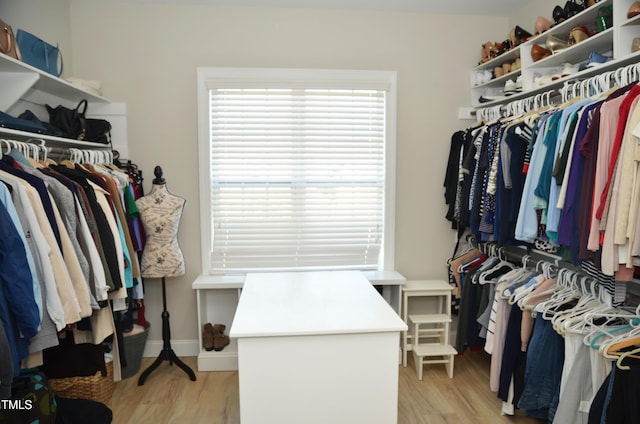 walk in closet featuring light hardwood / wood-style flooring