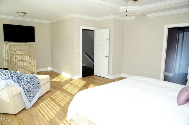 bedroom featuring ornamental molding and hardwood / wood-style floors