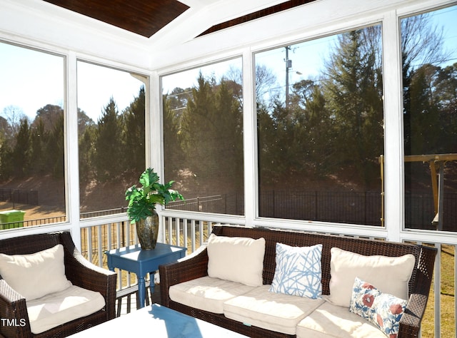 sunroom / solarium featuring lofted ceiling and plenty of natural light