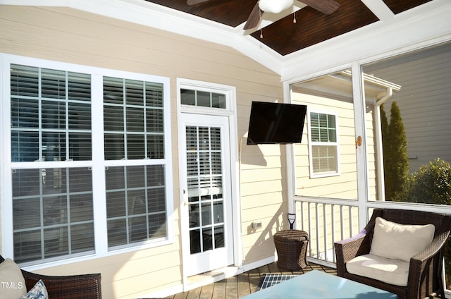 exterior space featuring ceiling fan and vaulted ceiling