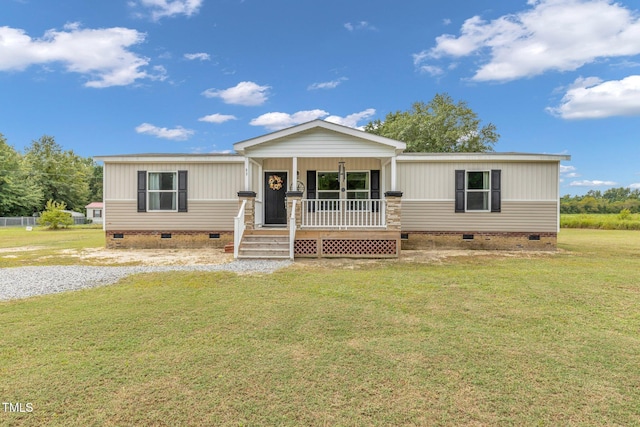 manufactured / mobile home featuring covered porch and a front lawn