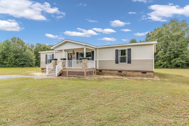 manufactured / mobile home featuring a front lawn and covered porch