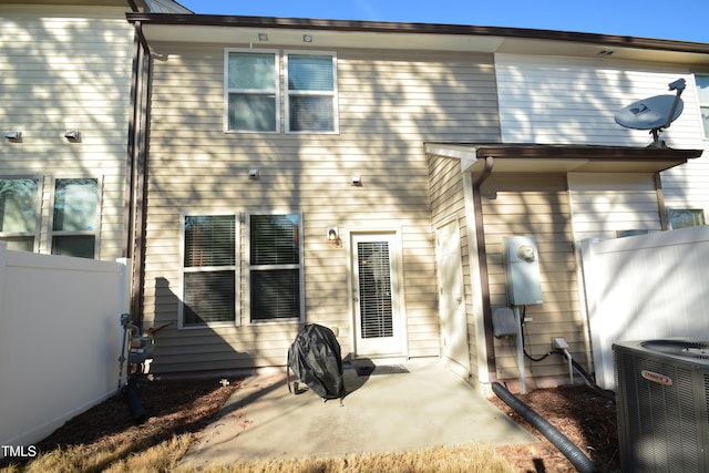 back of property featuring central AC and a patio