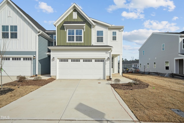 view of front of home with an attached garage, board and batten siding, and concrete driveway