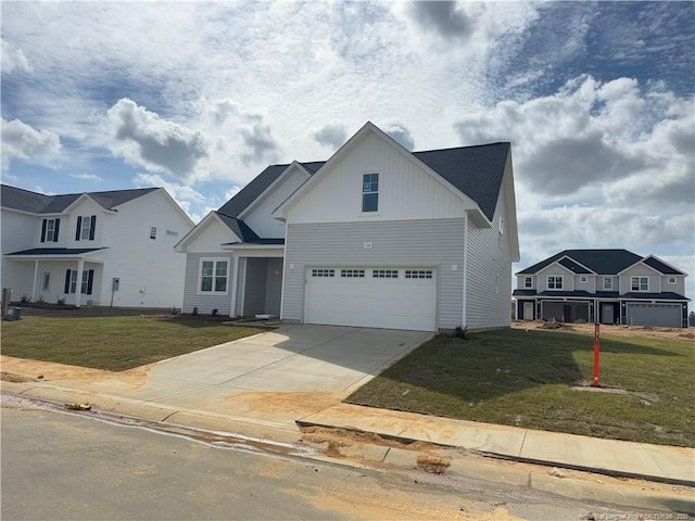 112 Peeler Cir, Raeford, NC 28376 - view of front of house featuring an attached garage, board and batten siding, concrete driveway, and a front lawn
