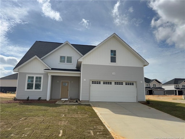 112 Peeler Cir, Raeford, NC 28376 - view of front of house featuring a garage, a front yard, board and batten siding, and concrete driveway