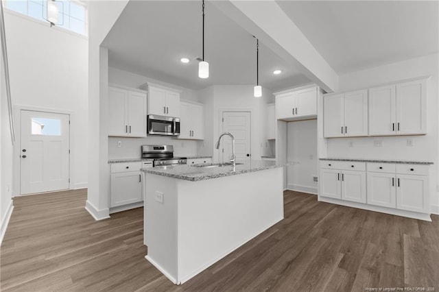 112 Peeler Cir, Raeford, NC 28376 - kitchen with stainless steel appliances, dark wood-style floors, white cabinetry, light stone countertops, and recessed lighting