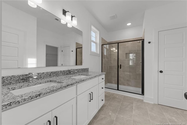 112 Peeler Cir, Raeford, NC 28376 - full bathroom featuring a shower stall, double vanity, recessed lighting, tile patterned flooring, and a closet