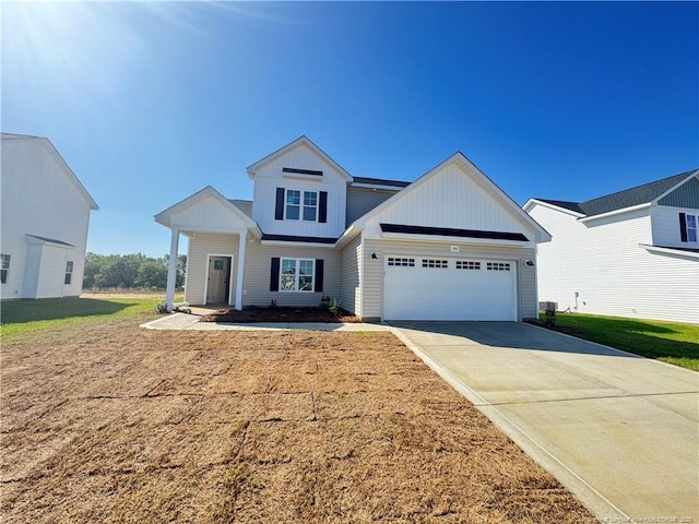 142 Peeler Cir, Raeford, NC 28376 - view of front of property with board and batten siding, an attached garage, concrete driveway, and a front yard