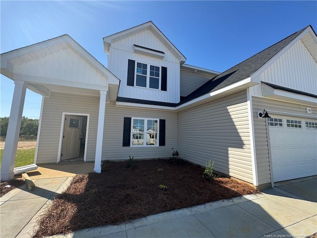 142 Peeler Cir, Raeford, NC 28376 - view of front of home with a garage, board and batten siding, and a shingled roof
