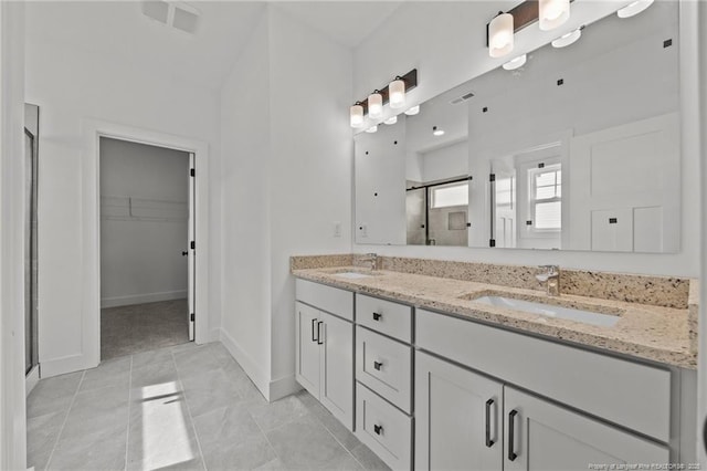 142 Peeler Cir, Raeford, NC 28376 - bathroom with a shower stall, double vanity, and a spacious closet