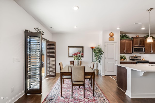 dining area with dark hardwood / wood-style flooring