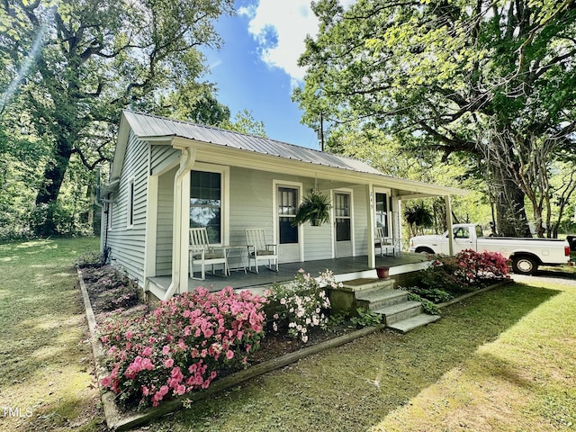 283 NC Highway 62 S, Yanceyville, NC 27379 - view of front of home featuring a porch, metal roof, and a front lawn