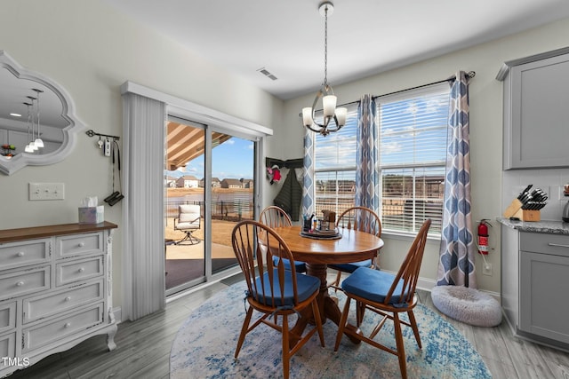 dining space featuring a chandelier and light hardwood / wood-style flooring