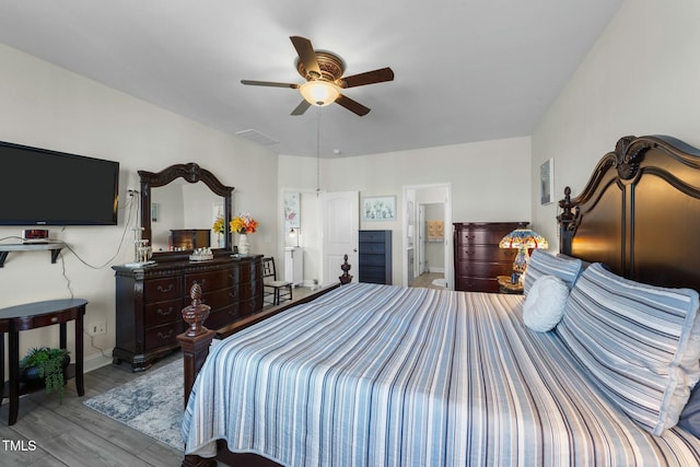 bedroom with ensuite bath, light hardwood / wood-style floors, and ceiling fan