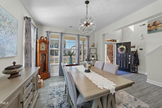 dining area featuring a notable chandelier and wood-type flooring