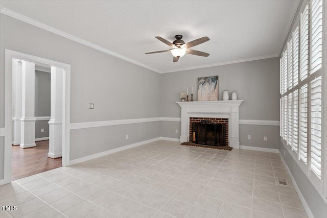 unfurnished living room with ceiling fan, ornamental molding, a fireplace, and light tile patterned floors