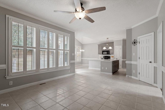 unfurnished living room featuring vaulted ceiling, light tile patterned flooring, ceiling fan with notable chandelier, crown molding, and a textured ceiling